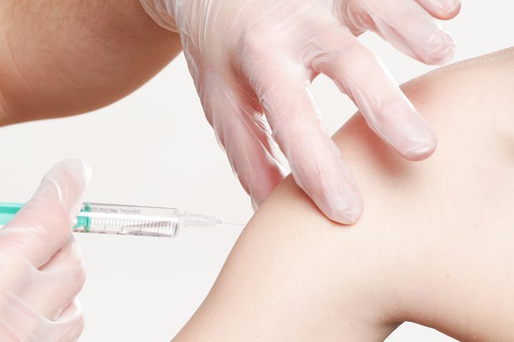 Person receiving corporate flu vaccination vouchers